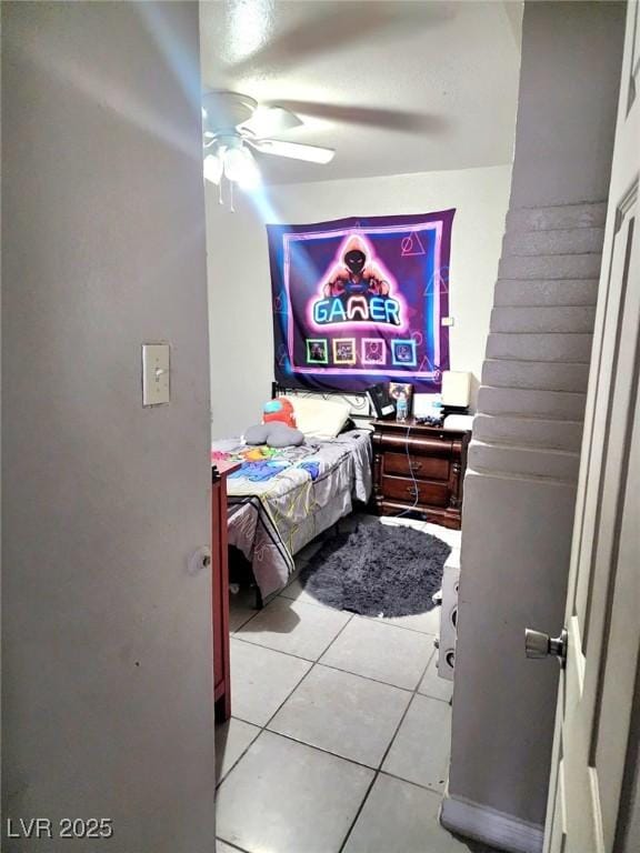 bedroom with light tile patterned floors and ceiling fan