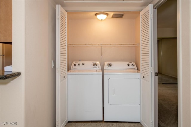 clothes washing area featuring washer and dryer and laundry area