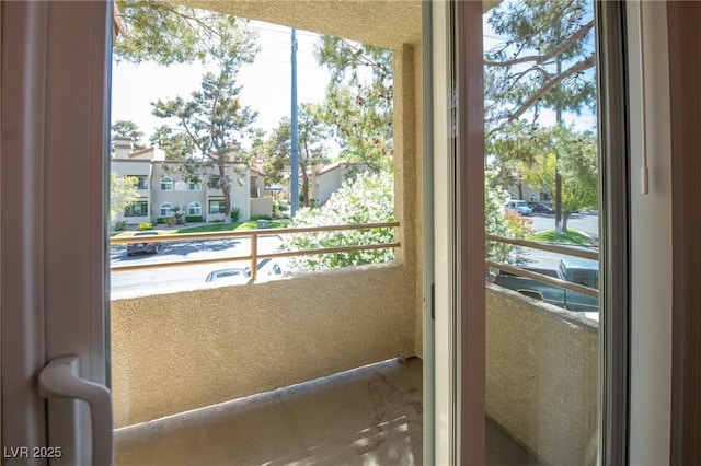 doorway featuring plenty of natural light and a residential view