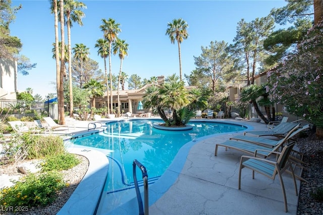 community pool featuring a patio area and fence