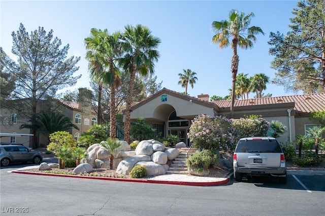 view of front of property with uncovered parking and stucco siding