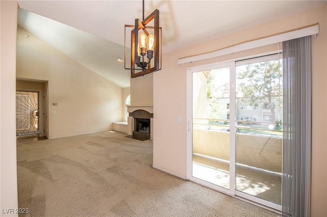 unfurnished living room with lofted ceiling, carpet floors, and a fireplace with flush hearth