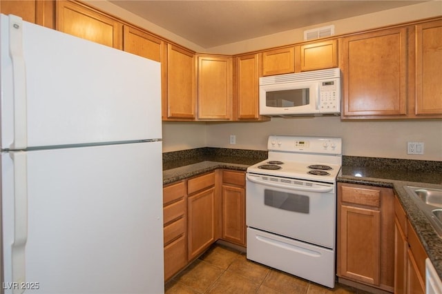 kitchen featuring white appliances, visible vents, and tile patterned floors