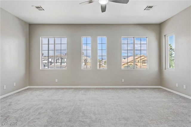 unfurnished room featuring a ceiling fan, carpet, visible vents, and baseboards