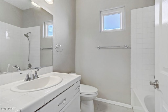 bathroom with baseboards, tile patterned floors, toilet, and a healthy amount of sunlight