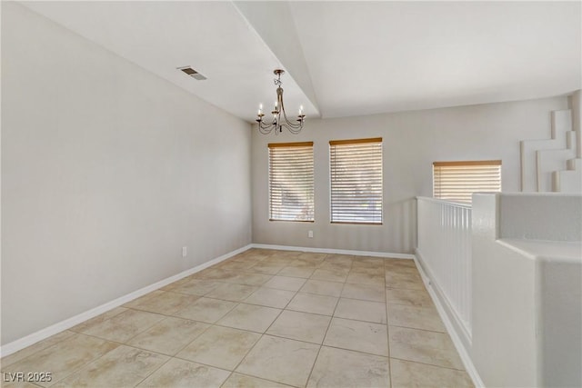 empty room with lofted ceiling, light tile patterned flooring, visible vents, baseboards, and an inviting chandelier