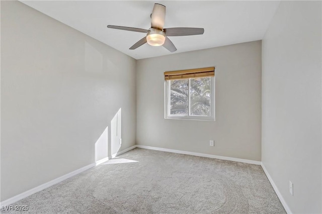 carpeted empty room with baseboards and a ceiling fan