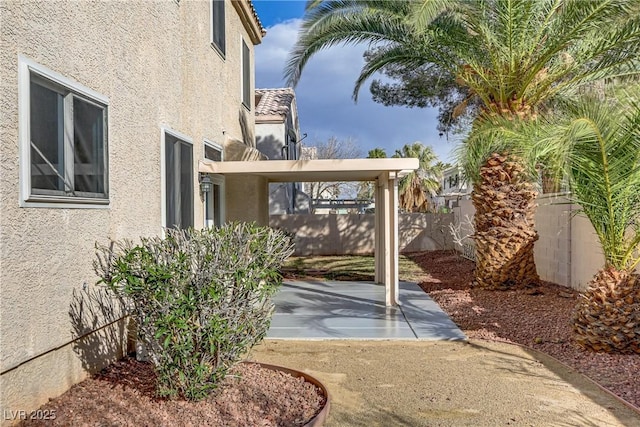 exterior space with a patio area and fence