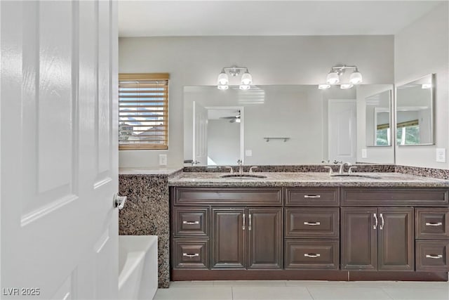 full bathroom with double vanity and a sink