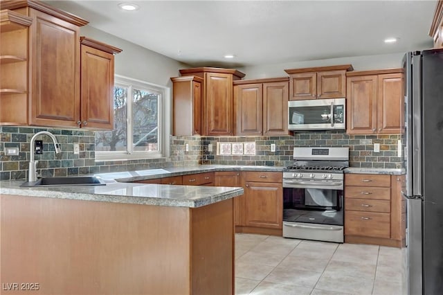 kitchen with stainless steel appliances, light tile patterned flooring, a sink, and decorative backsplash