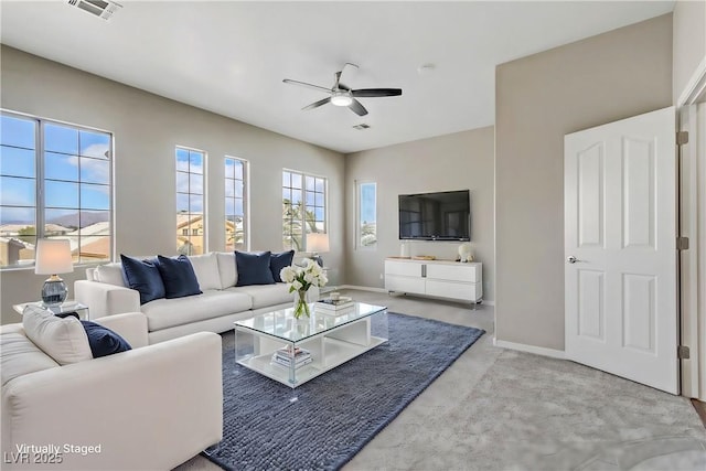 carpeted living area with visible vents, ceiling fan, and baseboards