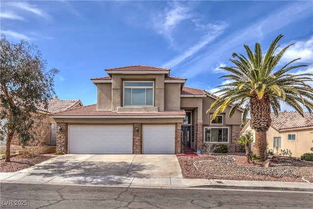 mediterranean / spanish-style house with driveway, a garage, and stucco siding