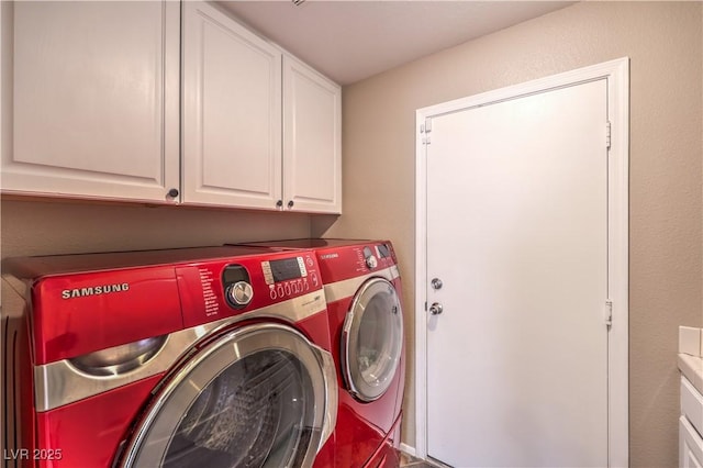 laundry area featuring cabinet space and washer and clothes dryer