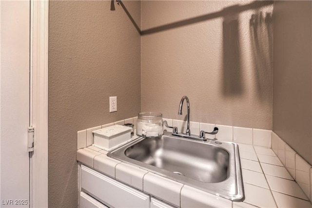 interior space with a sink and a textured wall