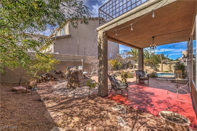 view of yard with a fenced backyard, a pool, and a patio