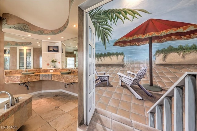 bathroom featuring tile patterned flooring, a sink, and recessed lighting