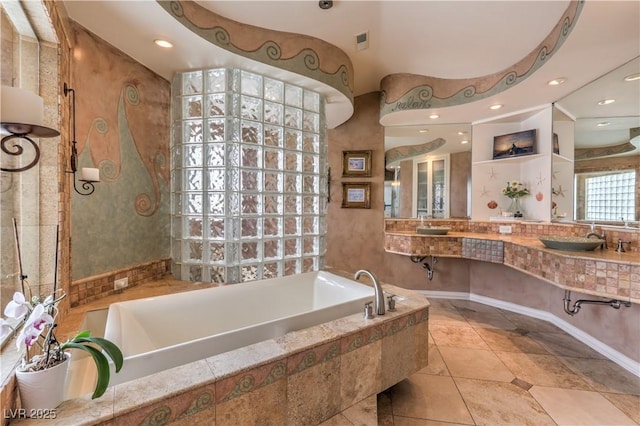 bathroom with a garden tub, visible vents, a sink, and recessed lighting