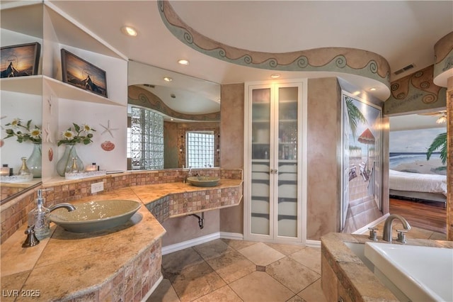 bathroom with a garden tub, recessed lighting, visible vents, connected bathroom, and vanity