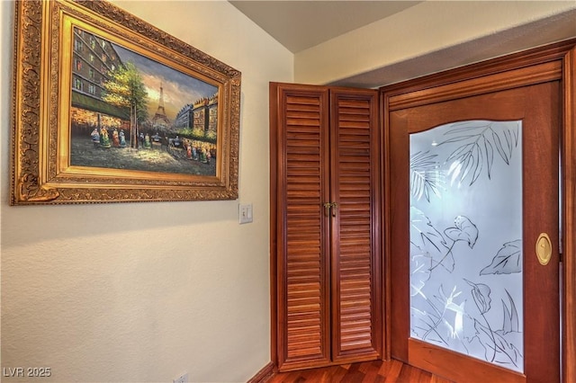 foyer featuring baseboards and wood finished floors