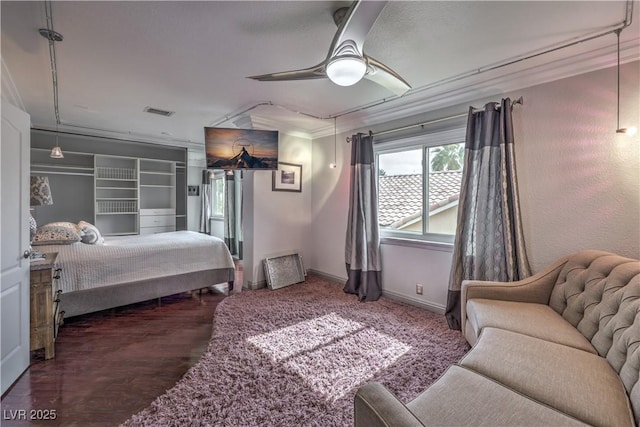 bedroom with visible vents, crown molding, baseboards, and ceiling fan