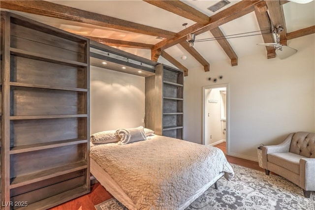 bedroom featuring visible vents, lofted ceiling with beams, baseboards, and wood finished floors