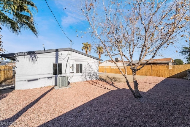 exterior space featuring a fenced backyard and cooling unit