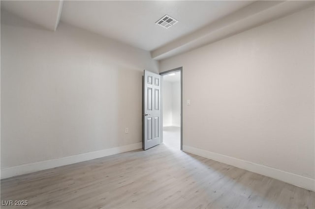 unfurnished room with light wood-style floors, baseboards, and visible vents