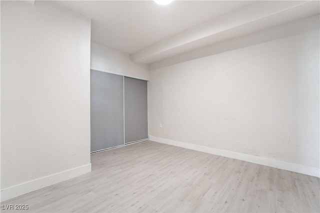 empty room featuring baseboards and wood finished floors