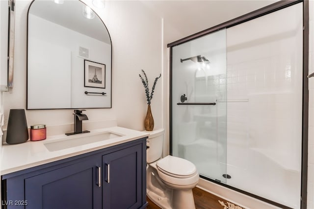 full bath with visible vents, toilet, wood finished floors, vanity, and a shower stall