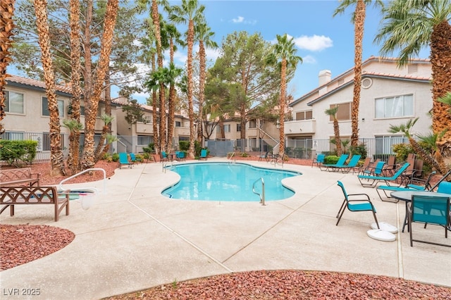 pool featuring a residential view, fence, and a patio