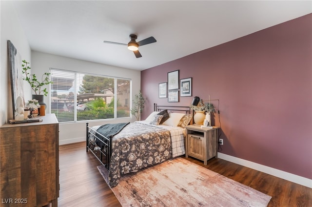 bedroom featuring ceiling fan, wood finished floors, and baseboards