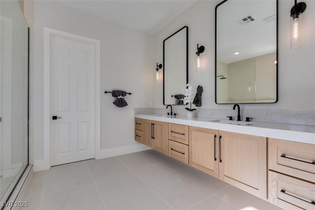 full bath featuring tile patterned flooring, a shower with shower door, a sink, visible vents, and double vanity