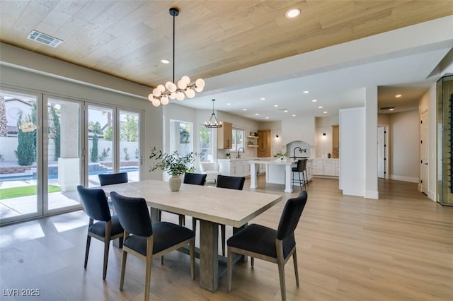 dining area with light wood-style flooring, visible vents, a notable chandelier, and recessed lighting