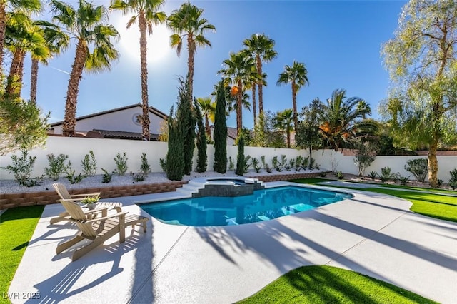 view of swimming pool with a patio area, a fenced backyard, and a pool with connected hot tub