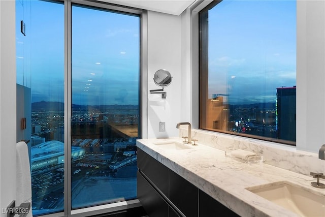 bathroom with a sink and double vanity