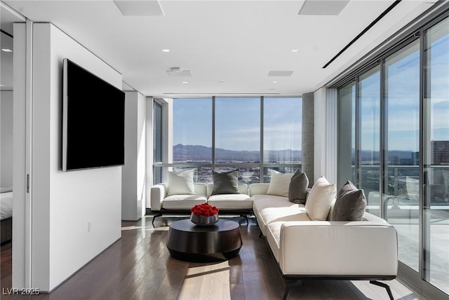 living room with hardwood / wood-style flooring and floor to ceiling windows