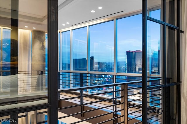 interior space with expansive windows, a view of city, and recessed lighting