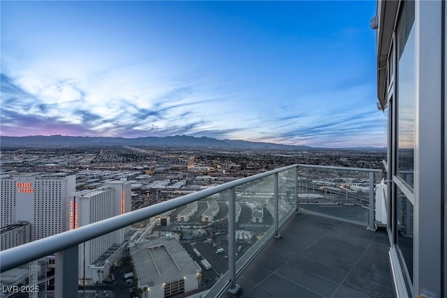 balcony at dusk with a view of city