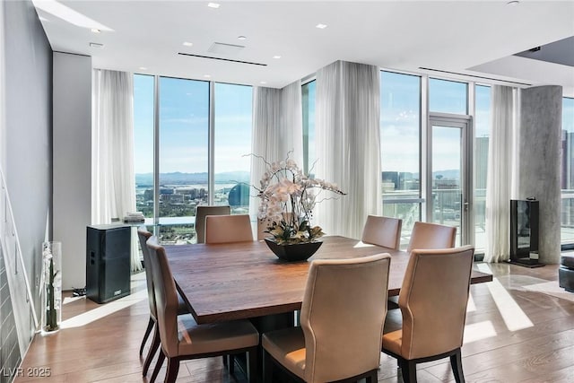 dining room featuring expansive windows and wood finished floors