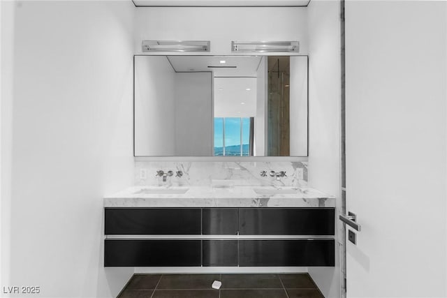 full bathroom with double vanity, tasteful backsplash, a sink, and tile patterned floors