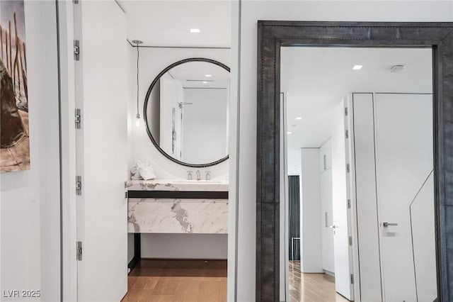 bathroom with vanity and wood finished floors