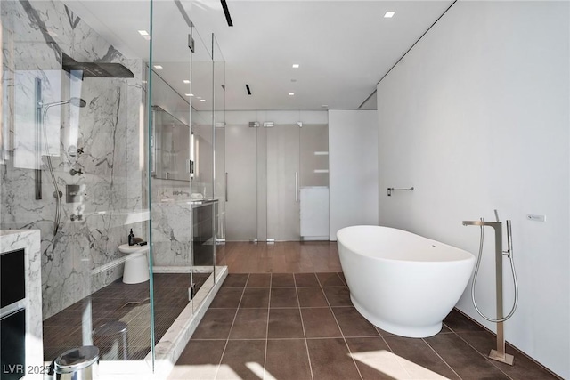 full bath featuring recessed lighting, a freestanding tub, a marble finish shower, and tile patterned floors