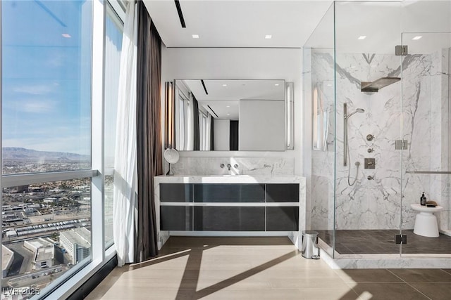 bathroom featuring vanity and a marble finish shower