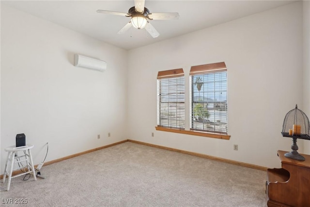 empty room with carpet floors, a wall unit AC, baseboards, and a ceiling fan