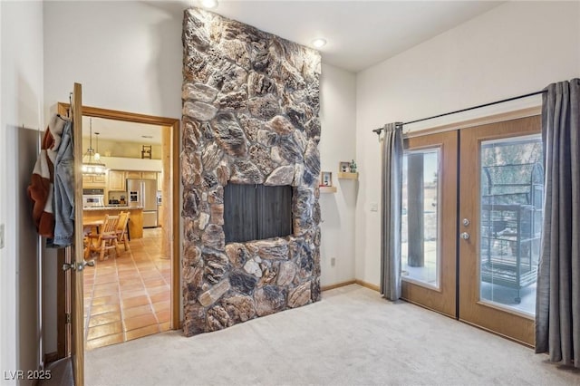 living area with french doors and light colored carpet