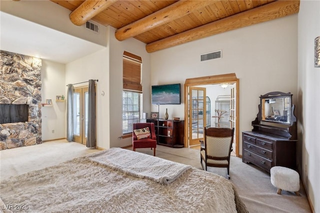 bedroom with wooden ceiling, visible vents, carpet flooring, and beamed ceiling