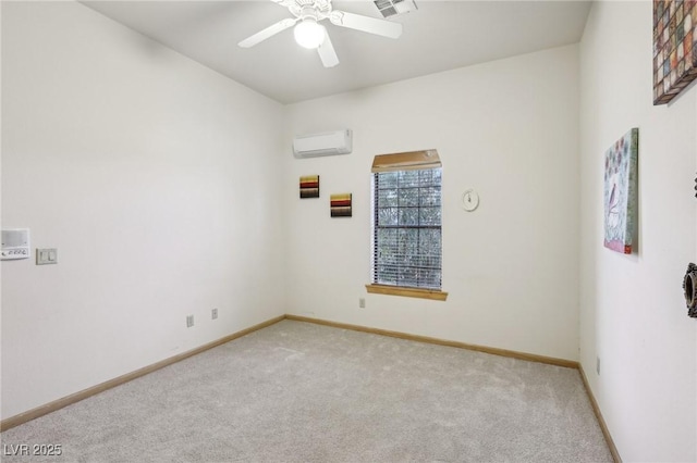 unfurnished room with light carpet, a wall unit AC, a ceiling fan, and baseboards