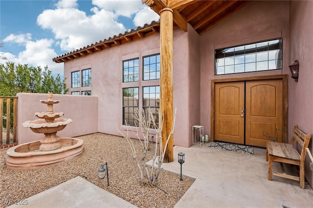 property entrance with stucco siding