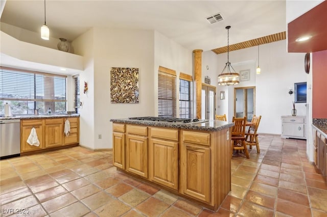 kitchen featuring hanging light fixtures, visible vents, stainless steel appliances, and dark stone countertops