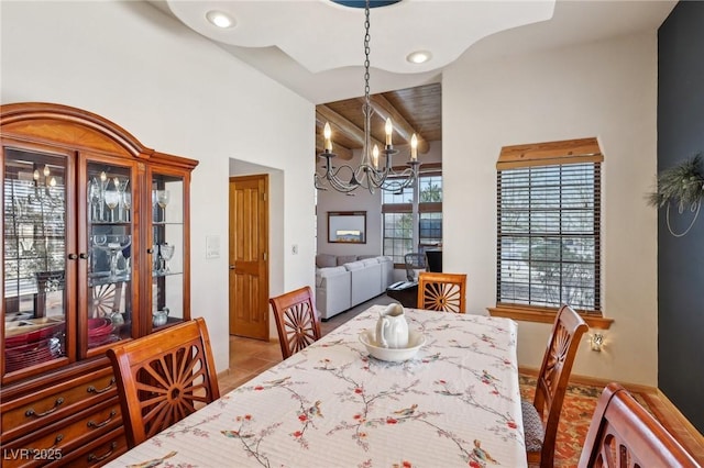 tiled dining room featuring lofted ceiling, recessed lighting, and an inviting chandelier